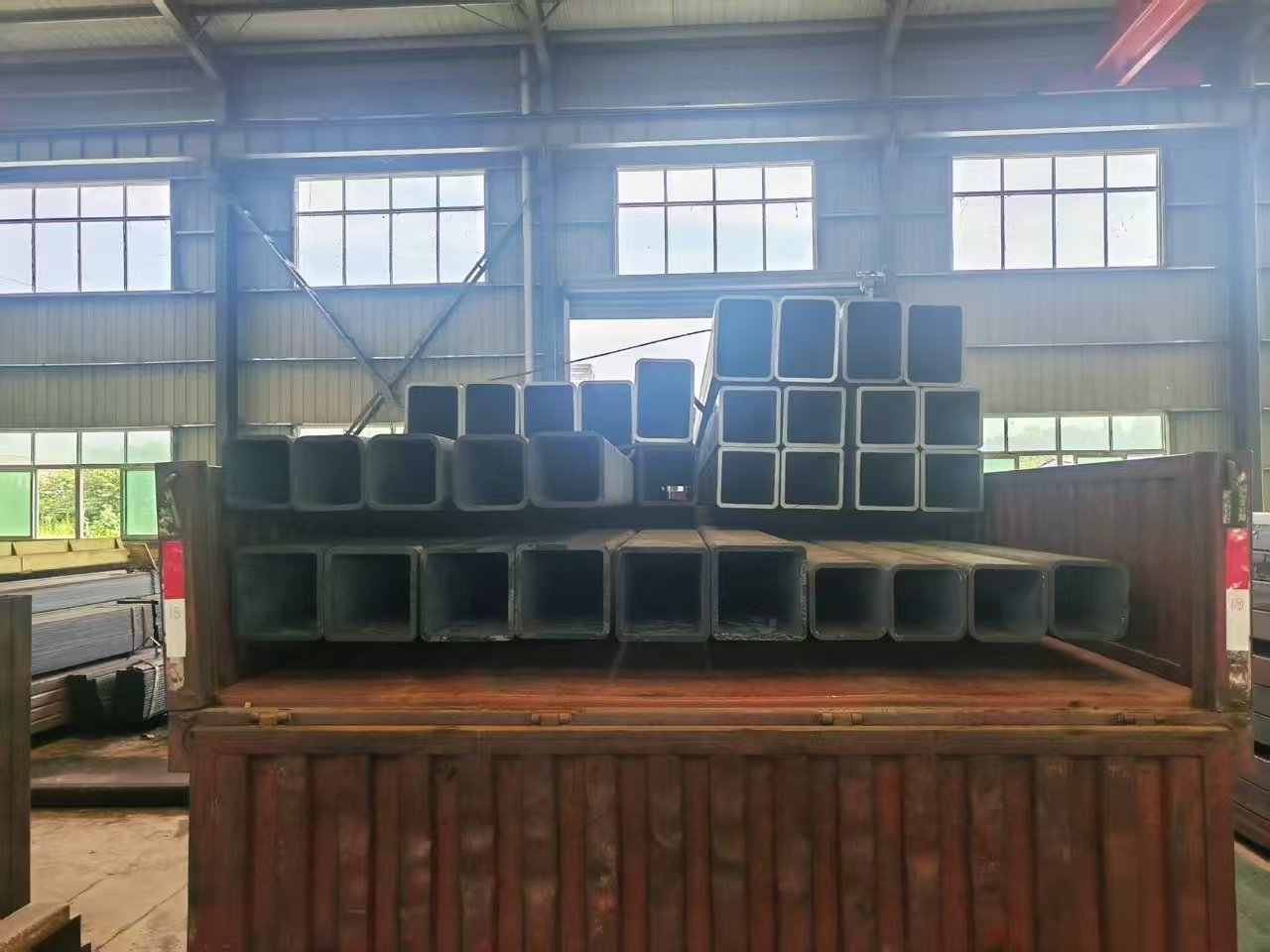 Bundled steel tubes stacked and strapped in the dispatch yard ready for export