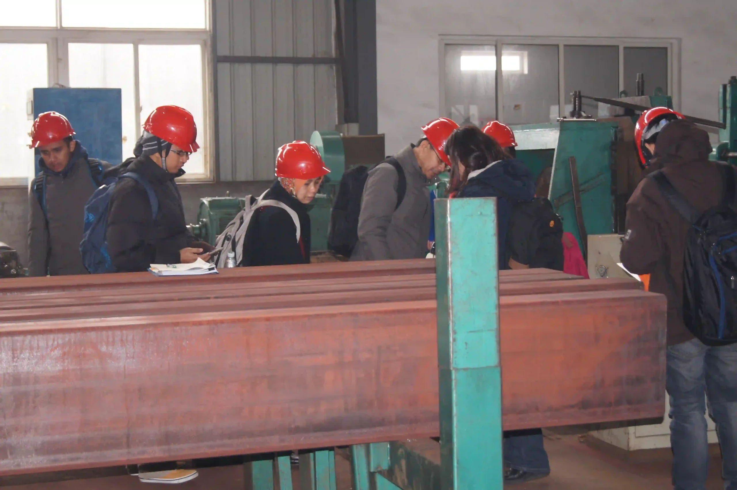 Buyer measuring wall thickness of a rectangular steel tube during pre-shipment inspection