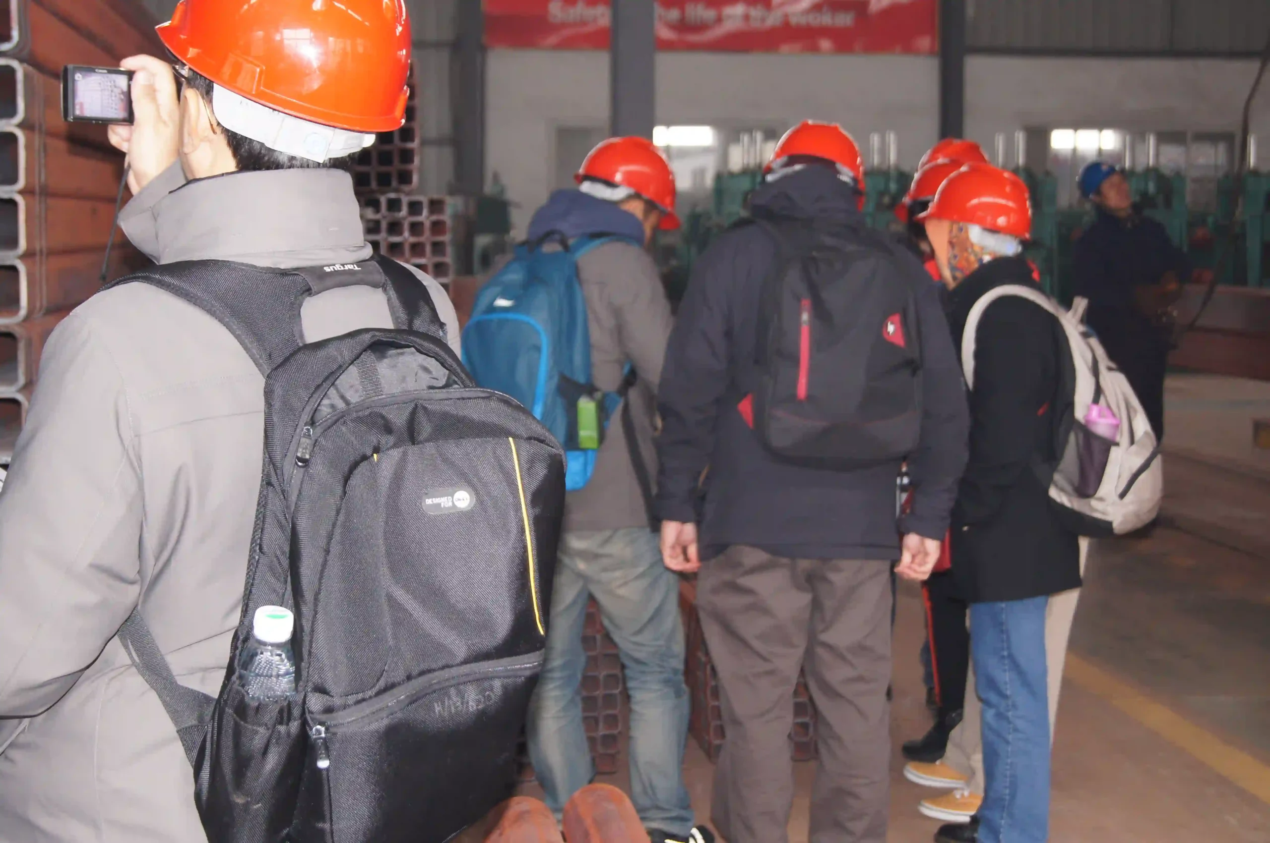 Client representatives reviewing production data at the cold forming line
