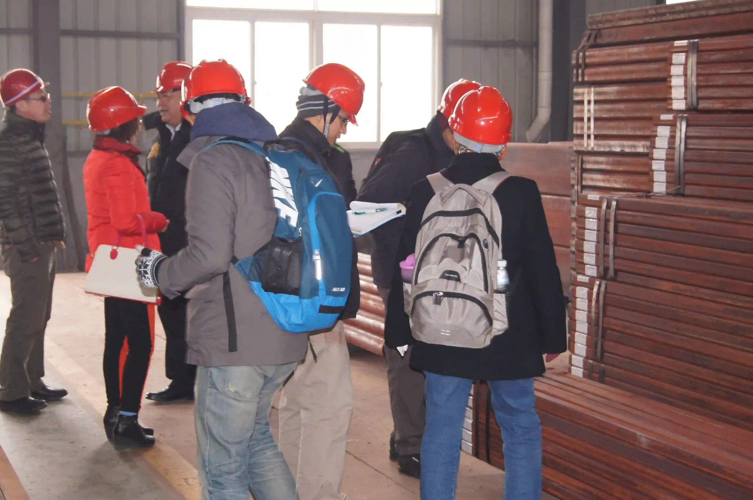 Overseas customers walking through the finished goods warehouse with a sales engineer