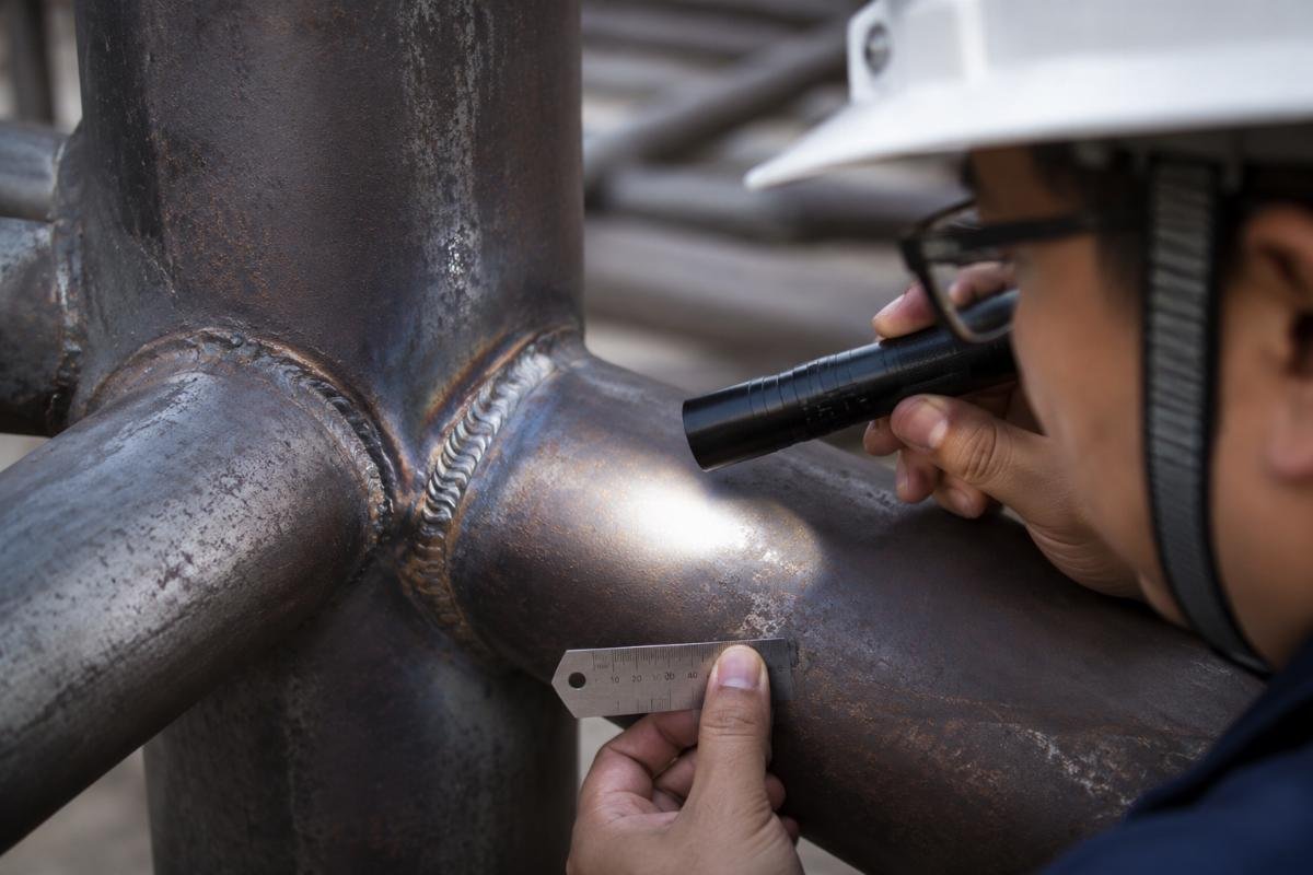 Close-up inspection of structural steel pipe for framework showing surface quality and weld seam
